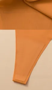 Detailed macro view of orange seamless ice silk fabric and reinforced lining texture