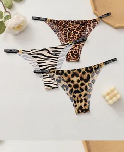 Detail view of seamless thong set with animal prints and gold ring decorative hardware
