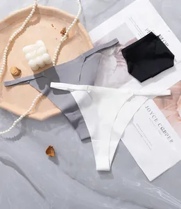 Flat lay of seamless thongs in grey, white, and black with thin elastic waistbands