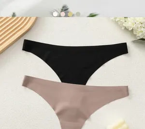 Flat lay detail of seamless thong underwear in black and pink with smooth cut edges