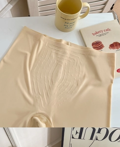 Detailed view of high-waist seamless tummy control underwear in beige with compression texture