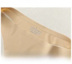 Close-up of seamless beige panties showing 75% polyamide fabric texture and printed label