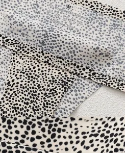 Detailed view of polka dot seamless underwear fabric with size M and material labels