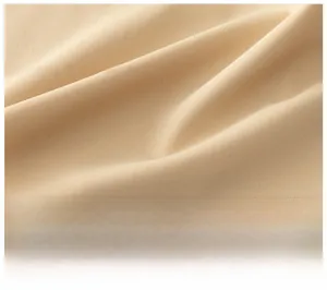 Detailed close-up of soft beige pure cotton fabric with antibacterial texture