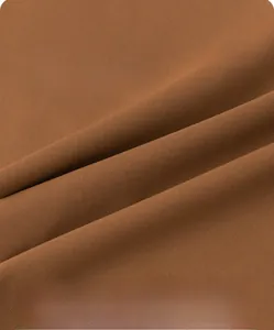 Macro view of brown ice silk fabric showing soft breathable texture and fine knit details
