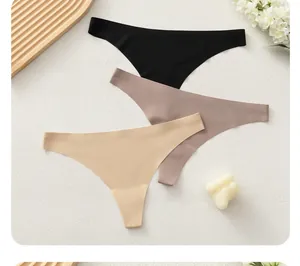Three-pack seamless thong set in black, nude and pink tones on a decorative background