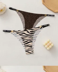 Detail of leopard and zebra print seamless thongs with gold rings and lettered waistband