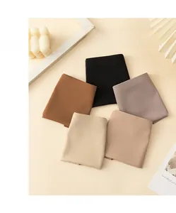 Flat lay of five seamless ice silk panties in neutral tones with soft, smooth fabric texture