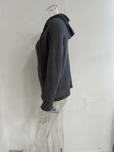 Detail view of dark grey waffle knit texture and ribbed cuff on hooded cardigan jacket