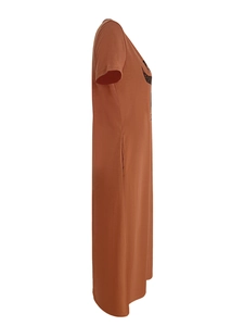 Detail shot of the caramel maxi dress showing a functional side pocket and cotton fabric