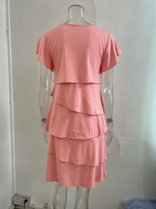 Rear view of pink layered tiered dress showing flutter sleeves and ruffled chiffon hem