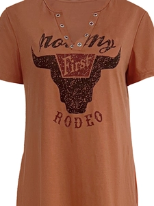 Detail of V-neckline with metal grommets and Not My First Rodeo print on rust dress