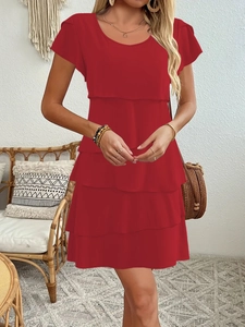 Detail of red tiered ruffled cake dress with elegant short sleeves and lightweight fabric