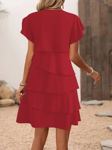 Back view of a red tiered summer dress with ruffle sleeves and a loose flowing silhouette