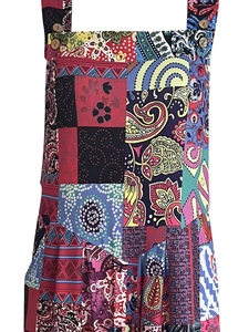 Detail of bohemian patchwork print jumpsuit with vintage wooden buttons on the straps