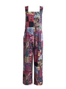 Detail view of colorful patchwork pattern and side buttons on bohemian wide-leg jumpsuit