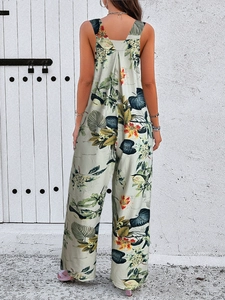 Detail of tropical floral print on summer jumpsuit with racerback and wide leg cut
