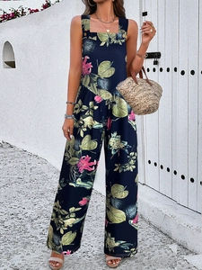 Detail of dark blue jumpsuit with pink floral print and tropical leaves on wide straps