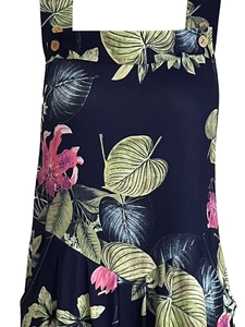 Close-up of tropical leaf print on summer jumpsuit with decorative wooden buttons