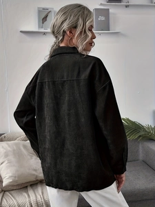 Detail showing the vertical ribbed corduroy fabric texture and loose fit back of the jacket