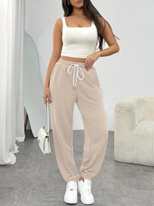 Women's high waist drawstring joggers in beige with side pockets and a relaxed fit