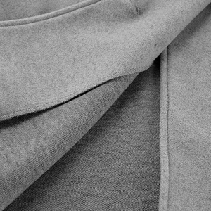Detail of light gray wool blend coat showing high-quality stitching and fabric texture