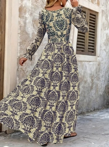 Vintage damask print long sleeve dress with V-neck and flowing A-line maxi silhouette