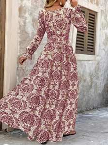 Detailed view of vintage reddish-brown damascus print on a beige maxi dress fabric