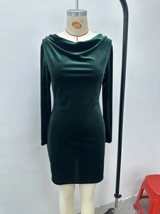 Detail of emerald green velvet dress showing the elegant cowl neck and soft texture