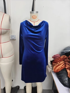 Detail of royal blue velvet dress showing cowl neck drape and shiny fabric texture