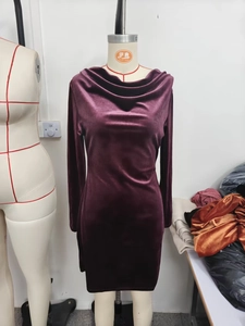 Detailed view of deep purple velvet long sleeve dress featuring a stylish cowl neck design