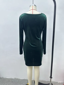 Detail of the back view of a dark green velvet bodycon dress with smooth texture