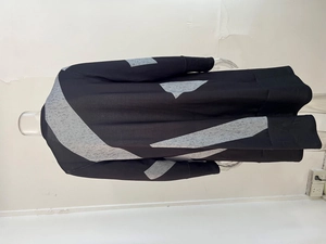 Detailed view of women's knitted cardigan featuring modern geometric patchwork design