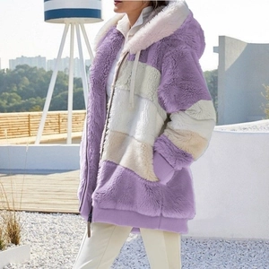 Detail of purple patchwork plush hoodie showing zip closure and ribbed elastic cuffs