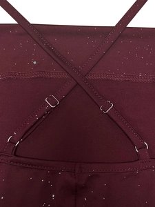 Macro shot of crisscross adjustable straps on burgundy dress with silver glitter