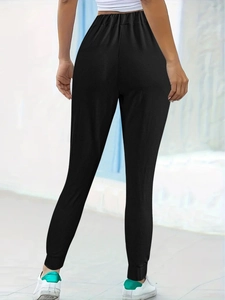 Detailed back view of black joggers for women featuring elastic waist and ribbed cuffs