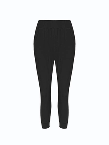Detail of high-waisted elastic waistband and side pockets on black joggers for women