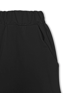 Detailed macro view of the elastic waistband and side pocket on black casual joggers