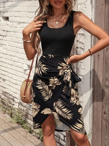 Detail of tropical palm leaf print wrap skirt with adjustable tie waist for vacation