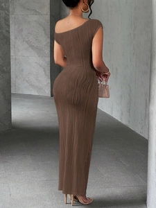 Detail of elegant brown maxi dress featuring unique vertical wavy pleated fabric texture