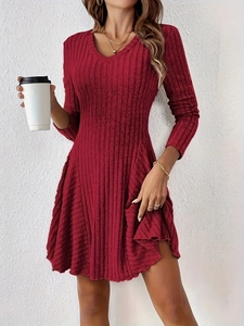 Detailed close-up of burgundy V-neck knitted A-line dress with vertical rib textures