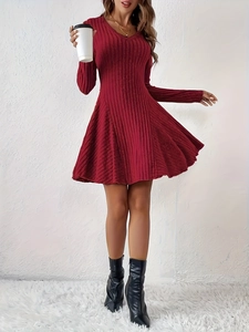 Detailed close-up of a red V-neck knitted dress featuring a soft vertical ribbed texture