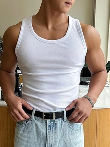 Detail of men's white ribbed tank top showing athletic fit and high-quality cotton fabric texture