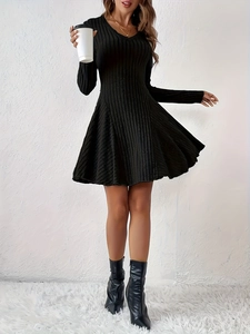 Detail view of the black knitted V-neck A-line dress with ribbed vertical texture