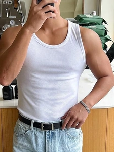 Close-up of men's white ribbed tank top showing fine cotton texture and slim fit design