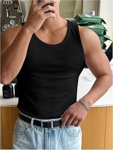 Close-up of black ribbed gym tank top showing elastic fabric texture on a male model