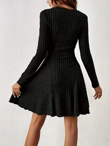 Detail shot of the back view of a black knitted A-line dress with vertical rib textures