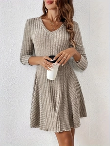 Detail of V-neck beige ribbed knit long sleeve A-line dress with soft texture