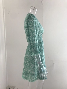 Detail of floral bohemian midi dress with elastic waist and ruffled sleeve cuffs