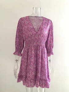 Detail of V-neck and smocked waist on a bohemian purple floral maxi dress